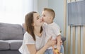 A little boy taking his mum in his arms in the bedroom Royalty Free Stock Photo