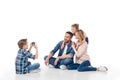 Little boy taking photo on his family on smartphone