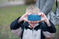 Little boy taking photos Royalty Free Stock Photo