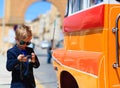 Little boy taking photos of traditional bus in Royalty Free Stock Photo