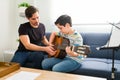 Little boy taking private music lessons at home Royalty Free Stock Photo