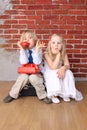 Little boy talking on phone, girl is bored Royalty Free Stock Photo