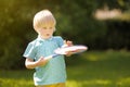 Little boy during tennis training or workout. Preschooler playing badminton in summer park. Child with small tennis racket and Royalty Free Stock Photo