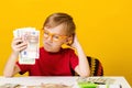 Little boy thinking where to invest money to make a profit. Financial literacy of children Royalty Free Stock Photo