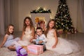 The little boy and three girls kids open Christmas presents new year winter Christmas tree Royalty Free Stock Photo