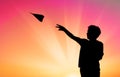 Little boy throwing paper plane silhouette Royalty Free Stock Photo