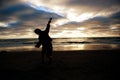 Little boy throwing sand at the beach