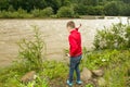 Little boy throwing stones in the water Royalty Free Stock Photo