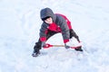A little boy throws a shovel snow in winter Royalty Free Stock Photo