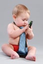 Little boy in tie play with cell phone Royalty Free Stock Photo