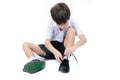 Little boy tie shoes ready for school on white background Royalty Free Stock Photo