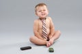 Little boy in tie speaks with cell phone Royalty Free Stock Photo