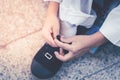 Little boy tighting his shoelaces for himself, Children learning to help himself with difficult task