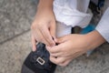 Little boy tighting shoelaces for himself