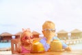 Little boy and toddler girl drinking coconut Royalty Free Stock Photo