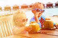 Little boy and toddler girl drinking coconut Royalty Free Stock Photo