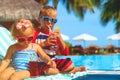 Little boy and toddler girl drinking juices on beach Royalty Free Stock Photo