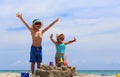 Little boy and toddler girl play with sand on beach Royalty Free Stock Photo