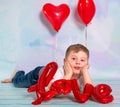 Little boy toddler with red heart balloonand love sign. Valentines day concept Royalty Free Stock Photo