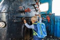 Little boy tourist considers controls Old black steam locomotive in Russia, Moscow railway station Royalty Free Stock Photo