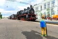 Little boy tourist meets Old black steam locomotive in Russia on the background of the Moscow railway station Royalty Free Stock Photo