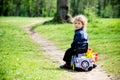 Little boy on a toy-car in park Royalty Free Stock Photo