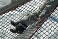 Little boy trains stability at the children`s rope center, playground for schoolchildren. A very torn net must be repaired or repl Royalty Free Stock Photo