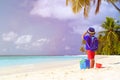 Little boy travel on beach with suitcase and Royalty Free Stock Photo