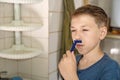 A little boy tries to shave and does not know how