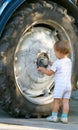 Little boy and truck wheel