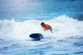 Little boy try to ride big wave in the sea Royalty Free Stock Photo