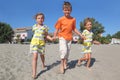 Little boy and two girls walking on beach Royalty Free Stock Photo