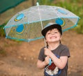 Little boy under umbrella