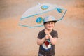 Little boy under umbrella