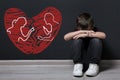 LIttle boy upset because of parents divorce on pink background. Illustration of broken heart and arguing couple Royalty Free Stock Photo