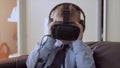 Little boy use virtual reality headset helmet, he very impressed