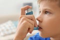 Little boy using asthma inhaler Royalty Free Stock Photo