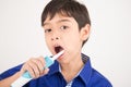 Little boy using electric toothbrushes dental healthcare on white background