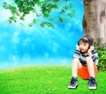 Little boy using headset in the park summer time