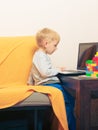 Little boy using laptop computer playing games Royalty Free Stock Photo