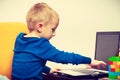 Little boy using laptop computer playing games Royalty Free Stock Photo