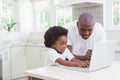Little boy using a laptop with his father Royalty Free Stock Photo
