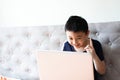 Little boy using laptop play game at home for relax Royalty Free Stock Photo