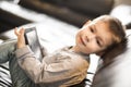 Little boy using tablet and sitting on sofa Royalty Free Stock Photo