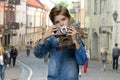 Little boy using vintage camera outdoor. Royalty Free Stock Photo