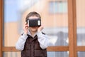 Little boy using VR virtual reality goggles