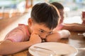 Little boy waiting for food in the restuarant