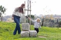 A little boy walking on the field holding his mother by hand Royalty Free Stock Photo