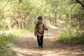 Little boy is walking through the forest. Hiking in mountain with walking stick and backpack. Little discoverer