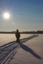 Little boy walking on the lake ice in Finland. There`s a lot of snow.